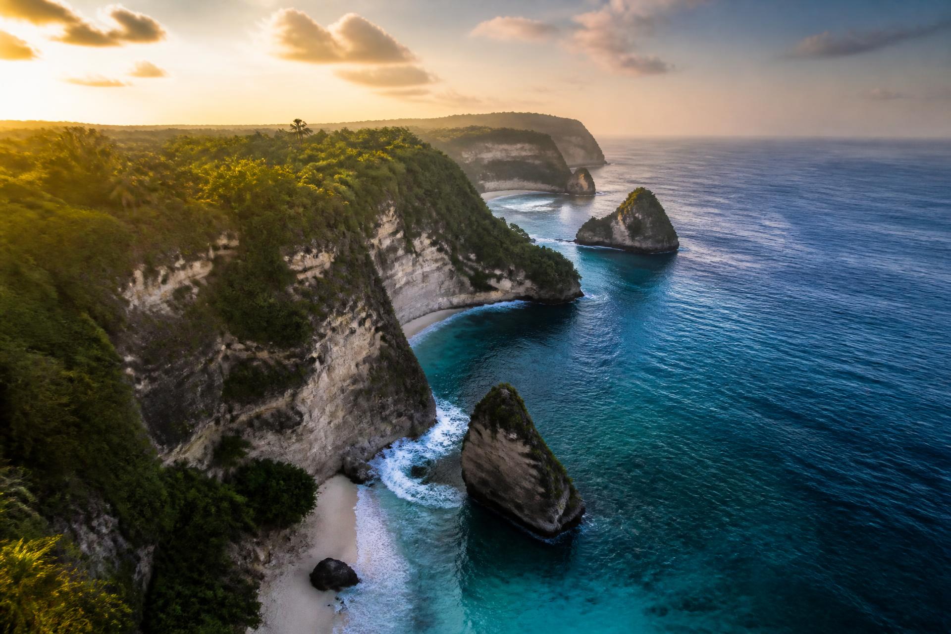 Aerial view of dramatic cliffs meeting the turquoise Caribbean at golden hour in Cabrera, Dominican Republic